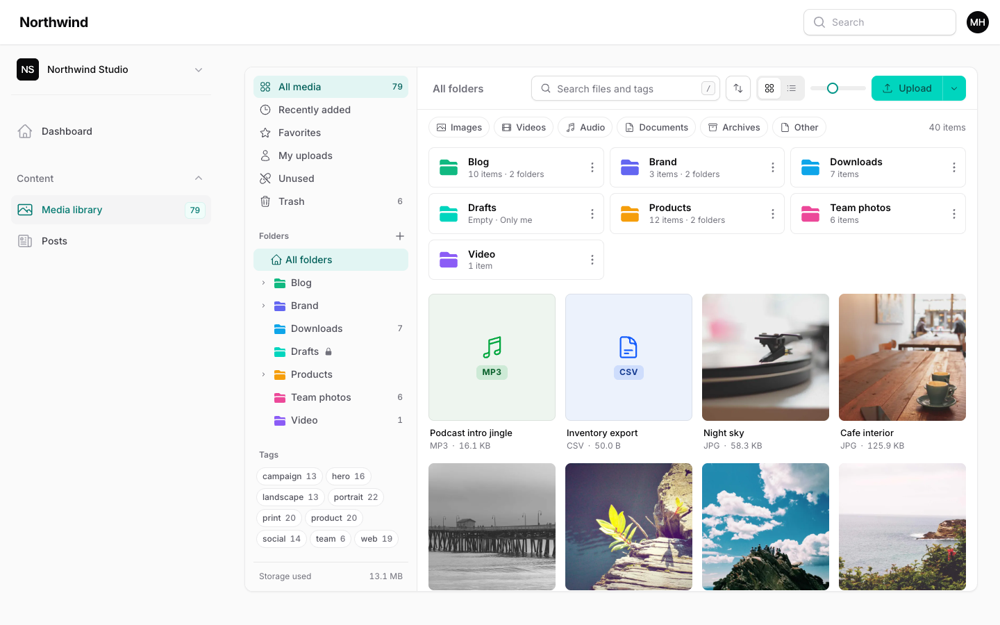 The media library in a Filament panel: folder tree, tags and a grid of photos